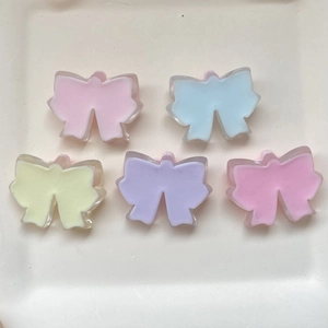 Macro shot of 5 assorted colorful translucent resin cherry blossom bow accessories