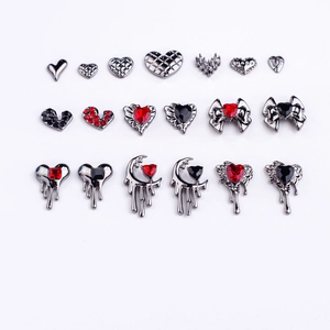 Gothic nail charms set featuring dark metal hearts, moon pendants, and red rhinestones