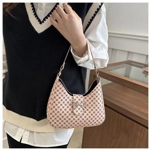 Detail of crescent shoulder bag with vintage monogram pattern and silver bow buckle