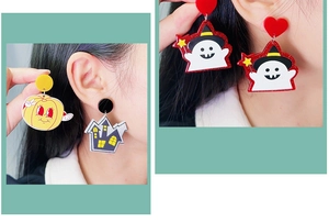 Detail showing acrylic Halloween drop earrings with cartoon pumpkin and ghost motifs