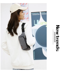 Grey Oxford fabric running waist bag featuring a functional headphone port and adjustable strap