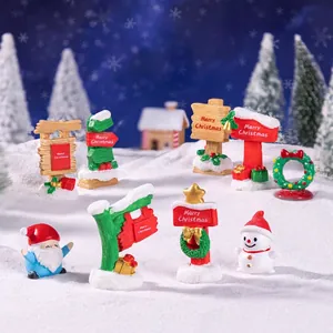 Miniature Christmas resin figurines set with signposts, Santa, and snowman on snow