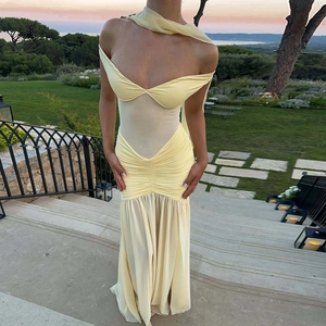 Detailed view of the sheer mesh patchwork and ruched waist on the yellow slit dress