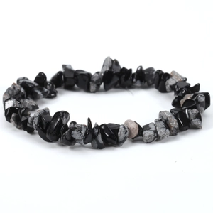 Detailed close-up of irregular black obsidian and snowflake stone elastic beaded bracelet