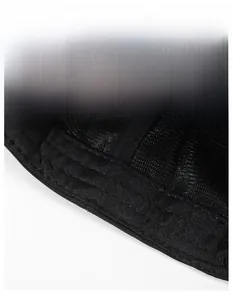 Close-up of a wide moisture-wicking sweatband on a black breathable mesh baseball cap