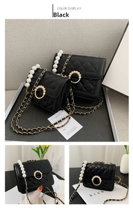 Detailed view of black quilted crossbody bag with pearl handle and golden chain strap