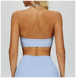 Detail of light blue backless yoga sports bra and high-waist leggings with matte finish