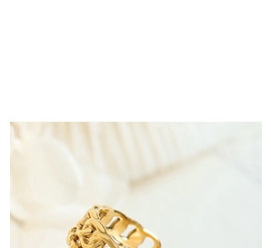 Close-up of golden titanium steel twisted chain ring with polished braided texture