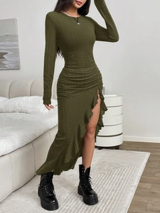 Detail of army green ribbed knit dress featuring side ruffles and asymmetric high slit hem