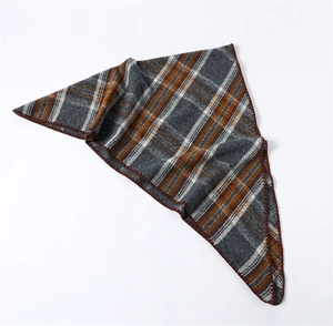 Detail of soft plaid scarf with dark grey patterns and red-brown stitched edges