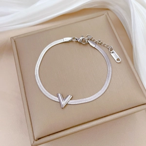 Detailed macro view of silver stainless steel snake chain bracelet with a V-shaped pendant