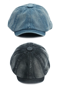 Detail of washed denim newsboy caps in blue and dark grey with vintage texture finish