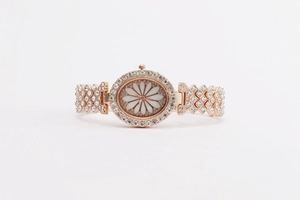 Detailed macro view of a rose gold women's watch featuring a daisy dial and crystal-set bezel