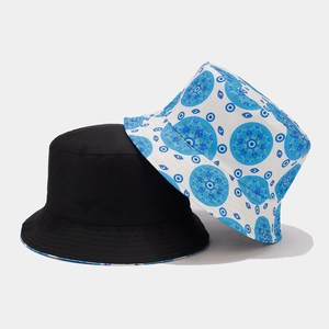 Detail of reversible bucket hat in black and blue evil eye pattern with mandala prints