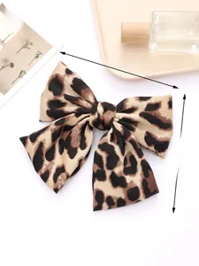 Detailed view of leopard print bow hair clip showing 20cm x 14cm size dimensions