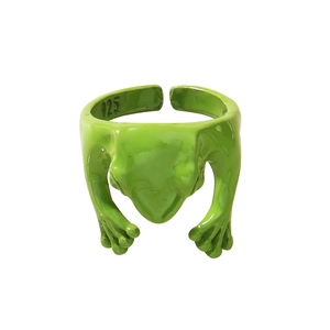 Macro shot of 925 silver stamp on a green funny frog-shaped open ring for women