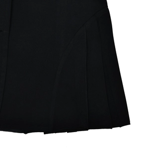 Close-up detail of the pleated hem and folded fabric on this black mini skirt dress
