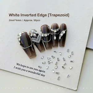 Macro detail of 2x4mm trapezoid nail zircons and brown gradient press-on nails