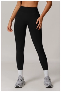Close-up of high-waisted black yoga pants featuring a wide ribbed tummy control waistband