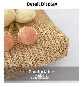 Close-up of handwoven straw texture with colorful fabric flower and berry details