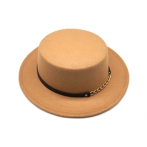 Detail of camel wool felt boater hat with black leather band and gold chain decoration