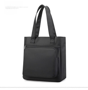 Side view of black water-resistant nylon tote bag with reinforced handles and front zipper