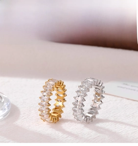 Macro shot of gold and silver eternity rings with marquise-cut cubic zirconia inlays