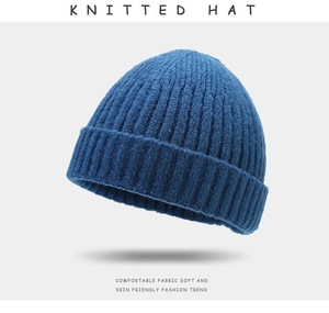 Detail of navy blue knitted hat showing ribbed texture and comfortable soft fabric