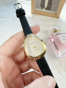 Detail shot of vintage snake-shaped water-drop dial with black leather strap