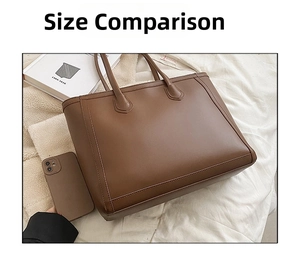 Detailed view of brown leather tote bag capacity compared to a phone on white bedding