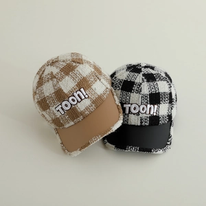 Detail of plaid tweed baseball caps with leather brims and TOON 3D embroidery