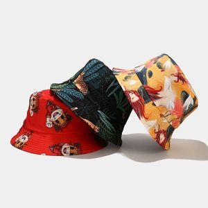 Three assorted cotton bucket hats with red zodiac, green palm, and yellow lion prints