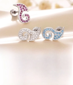 Detailed macro view of zircon earrings in red, blue and clear colors with titanium steel bar