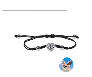 Detail of adjustable black braided bracelet with heart pendant and custom photo projection