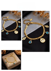 Detail of titanium steel double-layer chain bracelet with blue teardrop and evil eye