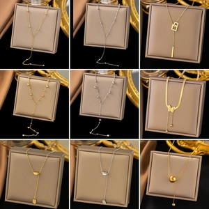 Collage of 18K gold and silver titanium necklaces with butterfly and geometric pendants