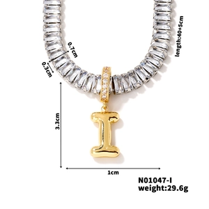 Detailed view of silver zircon chain with gold letter I pendant and dimension specs