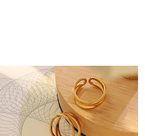 Detail view of a double-layered gold adjustable ring featuring a minimalist geometric design