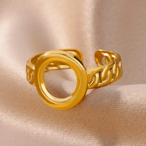Macro detail of 18k gold plated stainless steel ring with curb chain texture on satin