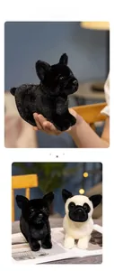 Close-up of black and spotted French Bulldog plush toys on a book for home decor