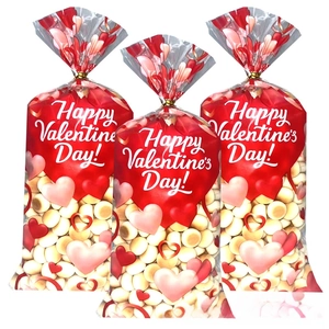 Three Valentine's Day OPP candy bags with pink hearts and golden twist ties