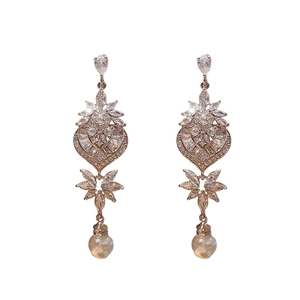 Elegant silver leaf heart drop earrings with crystals and pearls on white background