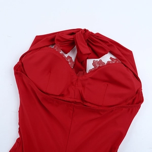 Detail view of red backless halter dress with delicate lace trim and elastic fabric