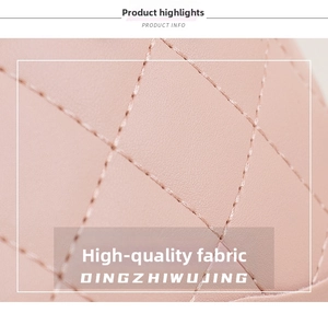 Detail shot of pink quilted leather fabric featuring high-quality rhombic embroidery patterns