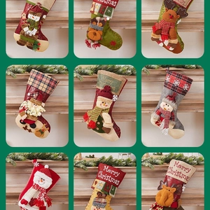 Various Christmas stocking hanging decorations with snowman and reindeer patterns