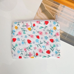 Detailed top view of a white floral cotton coin purse with strawberry and zipper closure