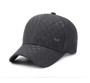 Close-up of a dark grey men's baseball cap with textured checkerboard fabric and logo