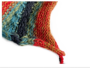 Close-up of multicolor knitted beanie showing intricate woolen stitch and tassels