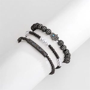 Three-piece beaded bracelet set featuring Hamsa hand charm and colorful zircon bar