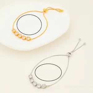 Detail of adjustable moon-shaped bracelets with cubic zirconia in gold and silver finish